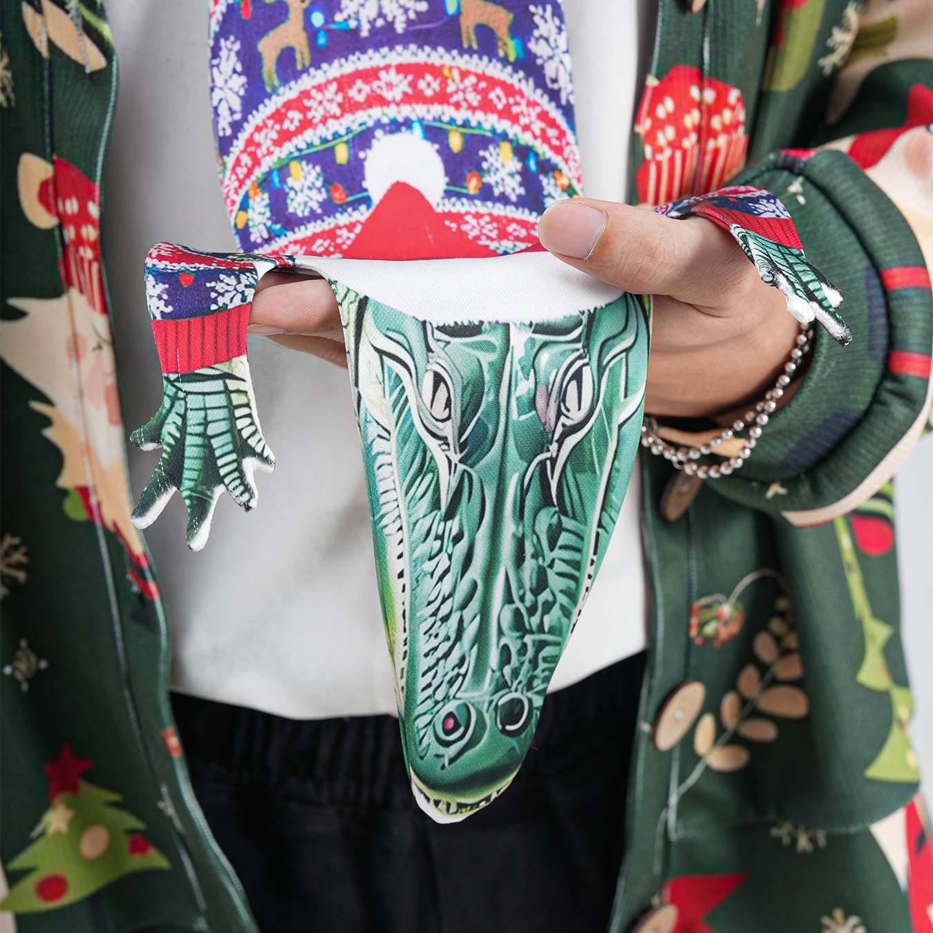 Novelty Christmas tie featuring an alligator wearing a Santa hat and holiday sweater, fun animal-themed festive accessory.
