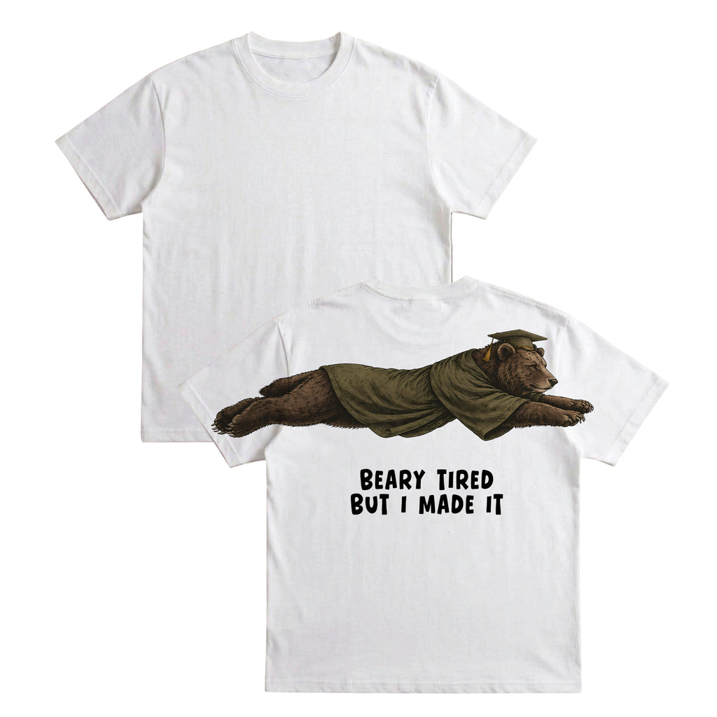 Bear Beary Tired But I Made It graduation graphic tee by Dripvity, unisex oversized white t-shirt with leaping bear in graduation cap and gown