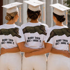 Bear Beary Tired But I Made It graduation graphic tee by Dripvity, unisex oversized white t-shirt with leaping bear in graduation cap and gown