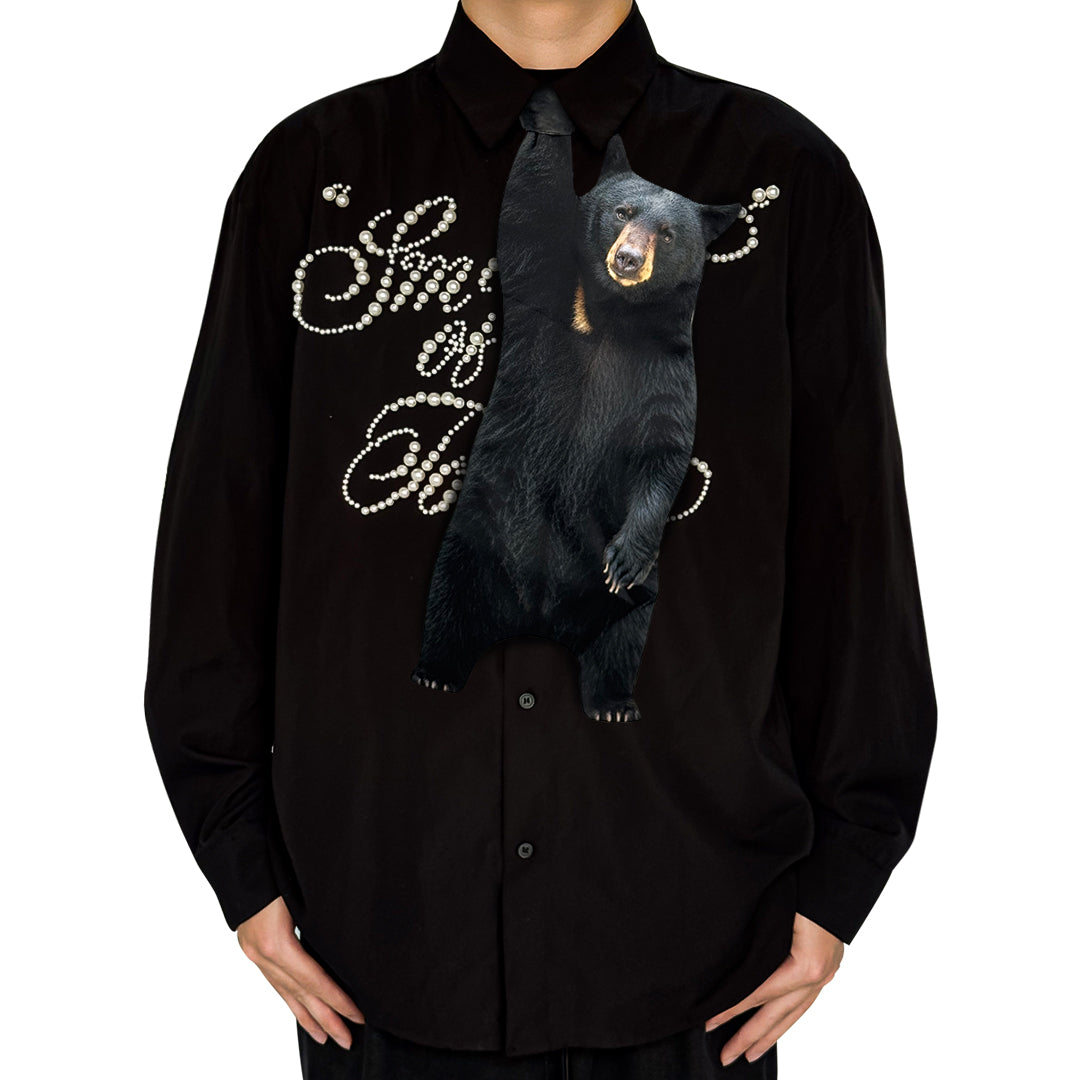 Novelty necktie featuring a realistic hanging black bear design, a fun and unique fashion accessory for nature and wildlife lovers.