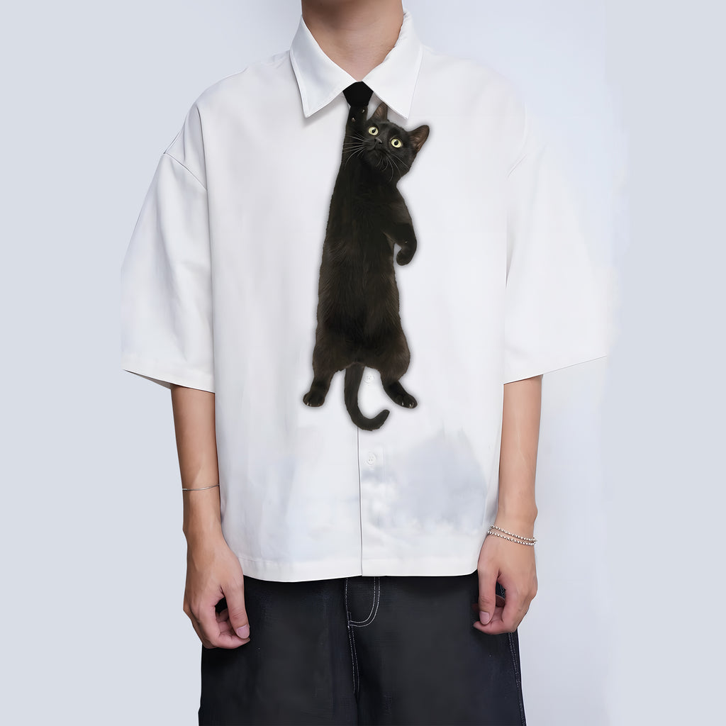 Novelty necktie featuring a realistic black cat appearing to hang from the wearer's collar