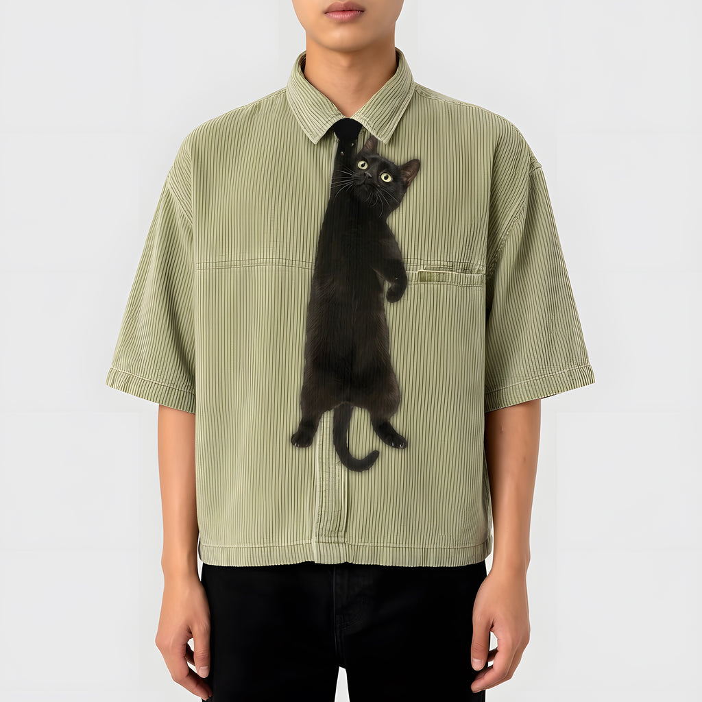 Novelty necktie featuring a realistic black cat appearing to hang from the wearer's collar