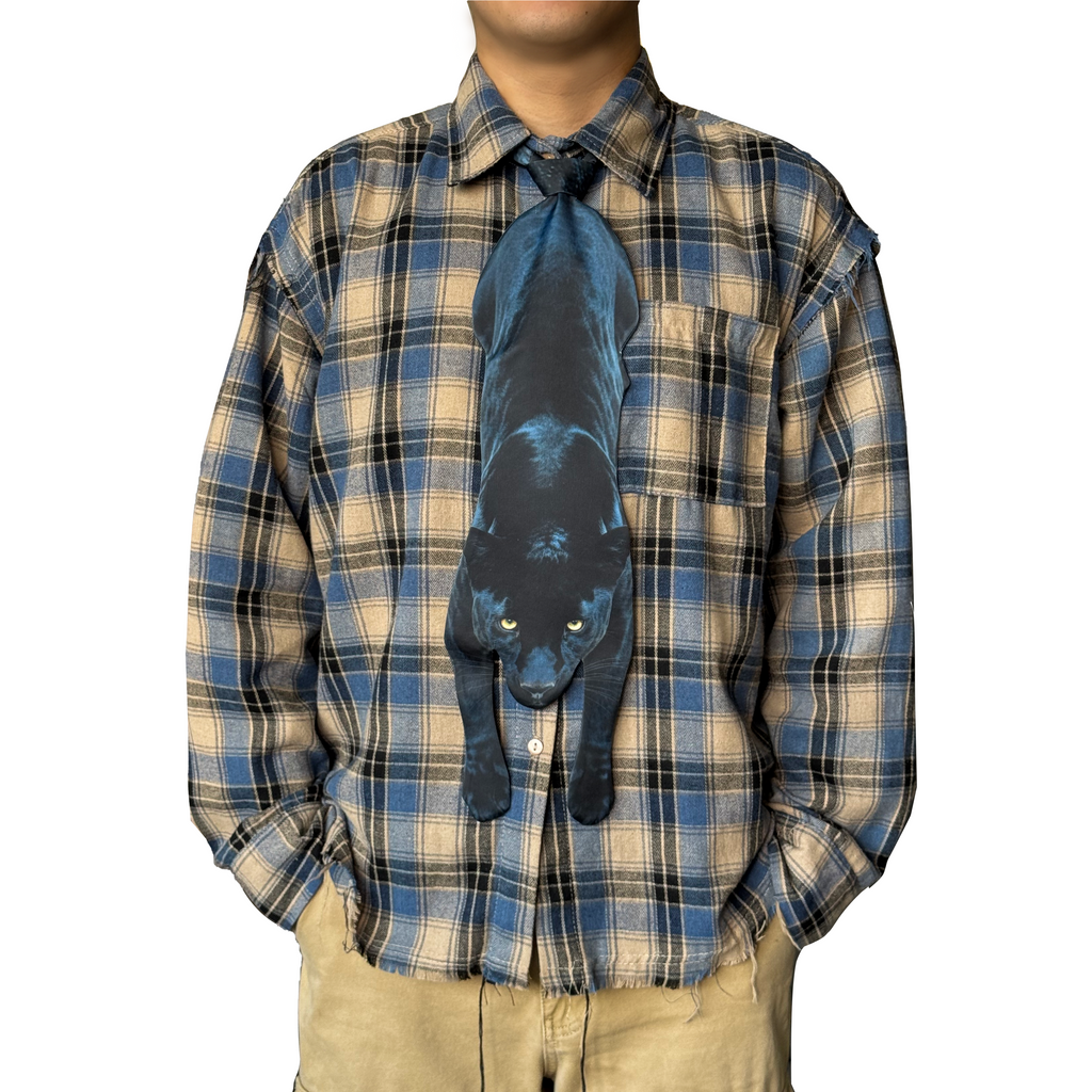 Novelty necktie featuring a realistic hanging black panther design, a sleek and unique fashion accessory.