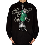 Novelty necktie featuring a realistic hanging grey cat wearing a green soccer jersey, a unique and playful fashion accessory for sports and pet lovers.