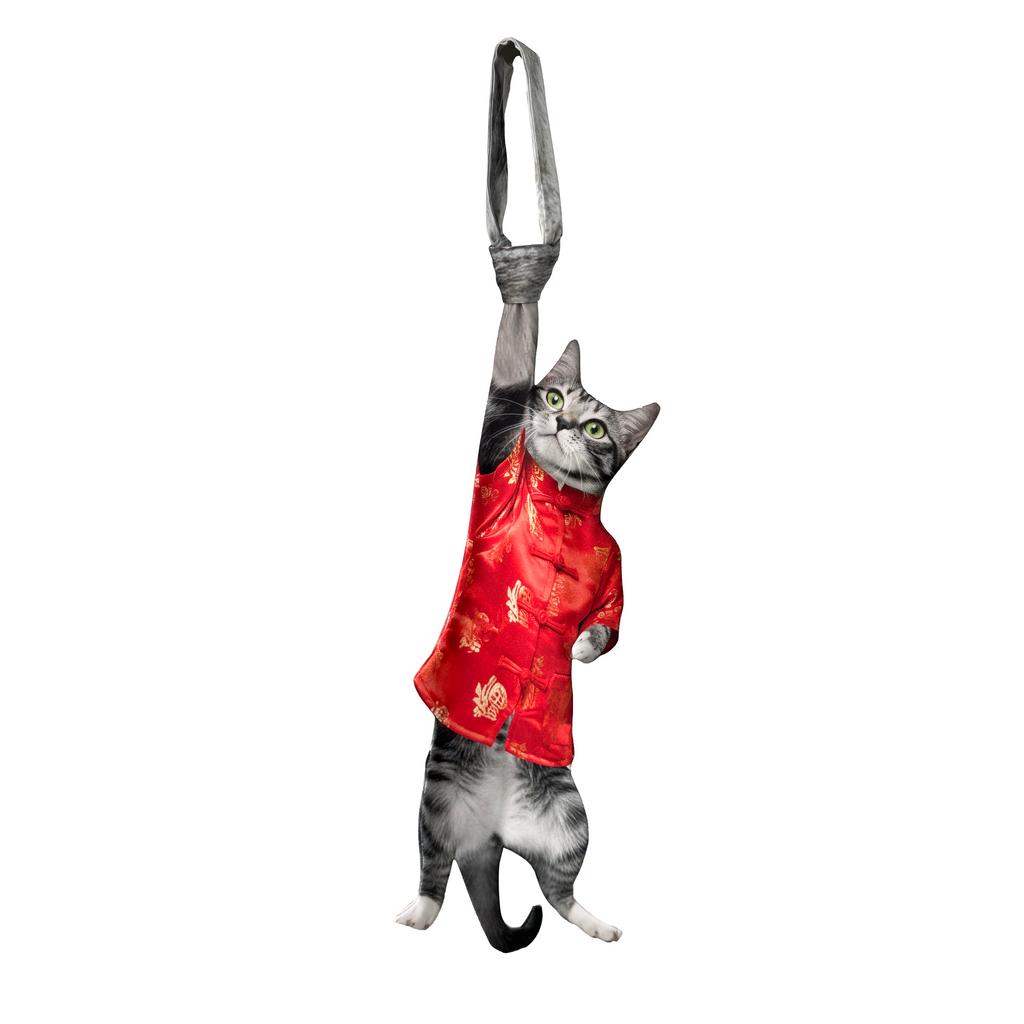 Novelty necktie featuring a realistic hanging grey cat wearing a festive red traditional-style top with gold patterns, a unique and eye-catching fashion accessory.