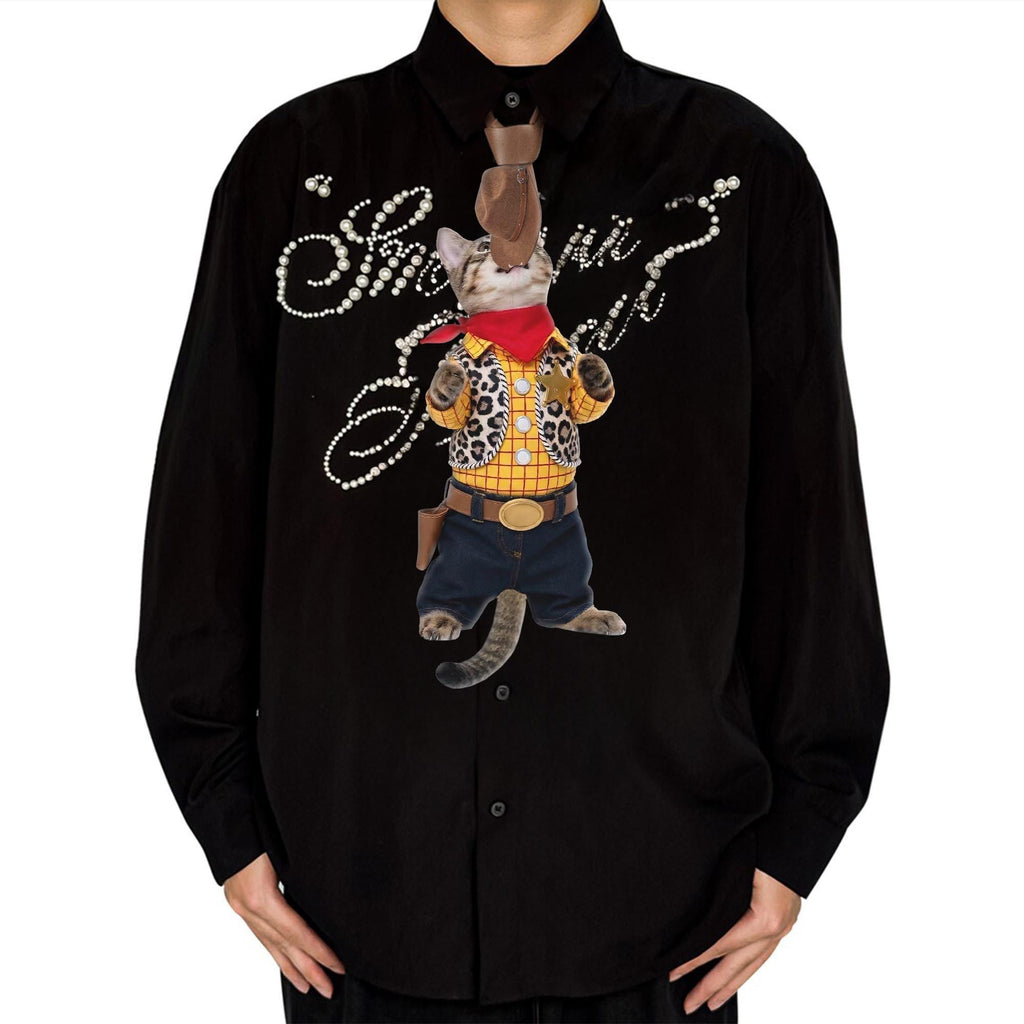 Novelty necktie featuring a tabby cat dressed as a cowboy, wearing a yellow plaid shirt, leopard print vest, jeans, bandana, and looking up at a dangling cowboy hat
