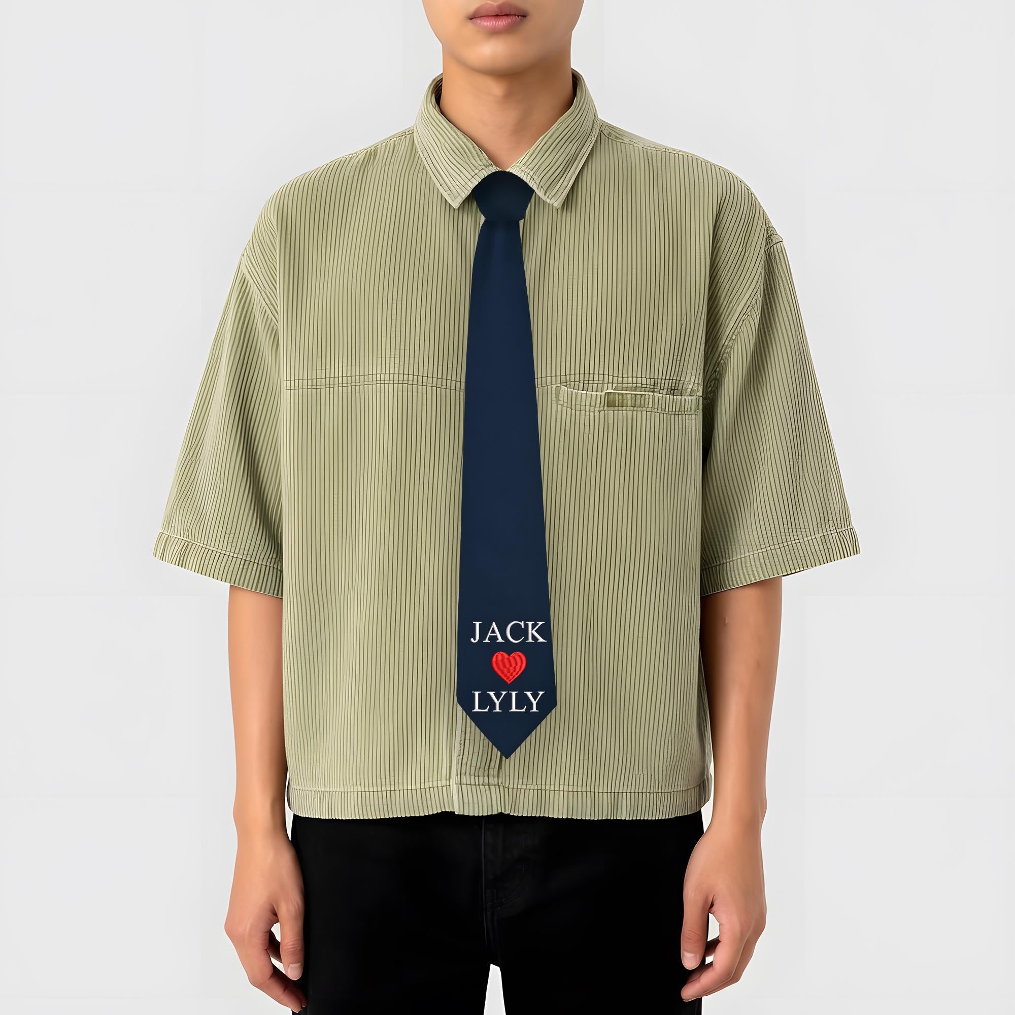 A dark blue custom necktie featuring the names 'JACK' and 'LYLY' embroidered with a red heart icon in the center, designed as a personalized gift