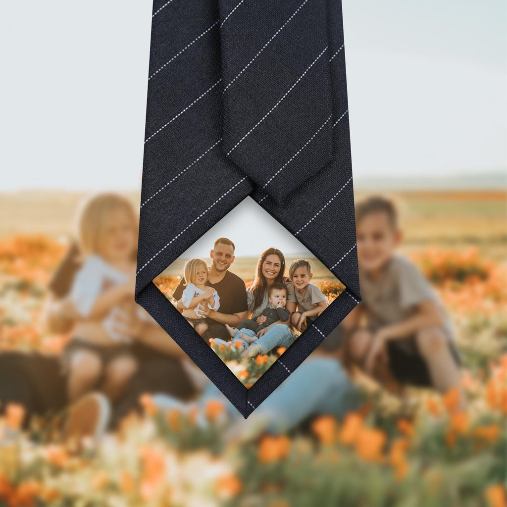 A set of one red and one black necktie, each featuring a custom-printed family photograph at the bottom tip, presented as a personalized gift option.