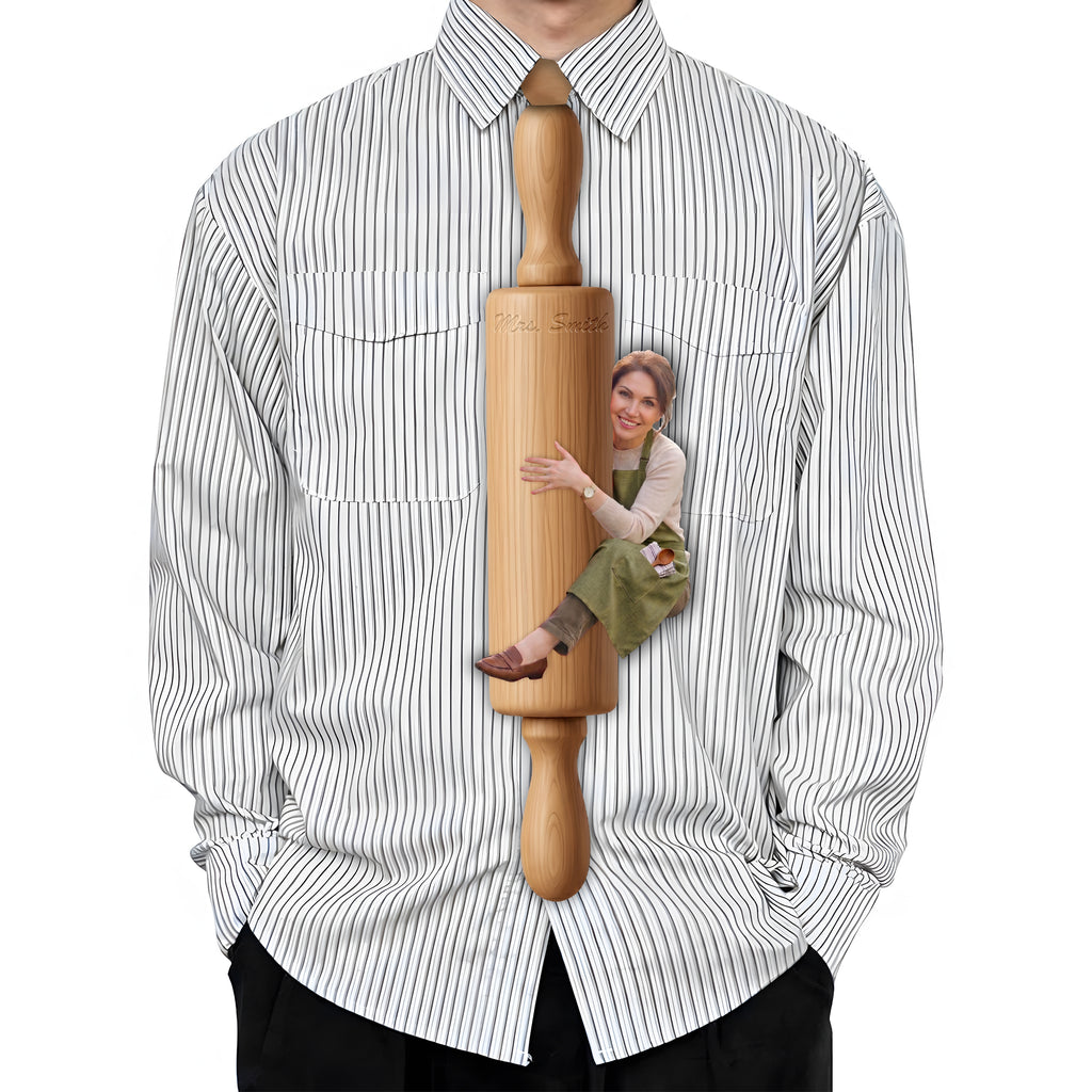 Novelty necktie featuring a graphic print of a person, dressed in an apron, hugging a wooden rolling pin. Text on the rolling pin reads 'Mrs. Smith
