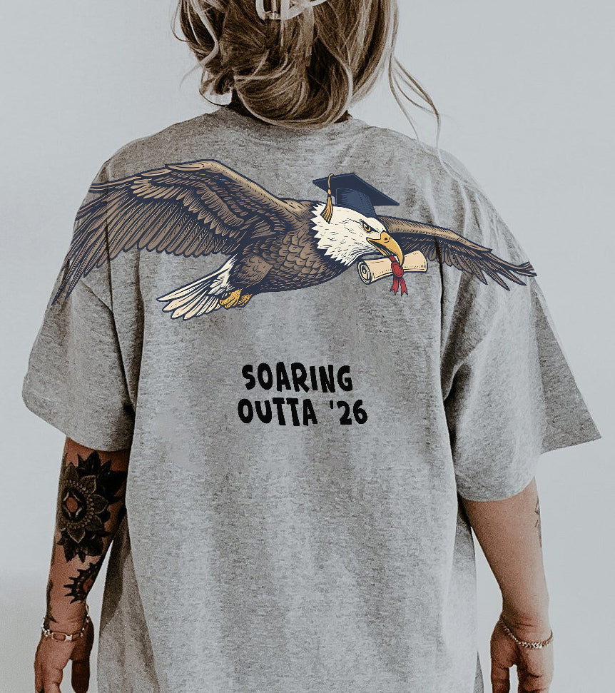 Eagle Soaring Outta 26 graduation graphic tee by Dripvity, unisex oversized white t-shirt with flying bald eagle in graduation cap and diploma