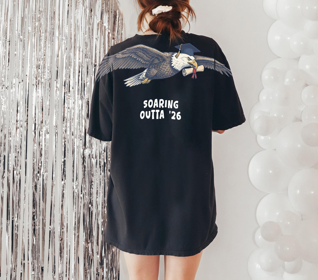 Eagle Soaring Outta 26 graduation graphic tee by Dripvity, unisex oversized white t-shirt with flying bald eagle in graduation cap and diploma