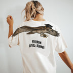 Eagle Soaring Outta 26 graduation graphic tee by Dripvity, unisex oversized white t-shirt with flying bald eagle in graduation cap and diploma