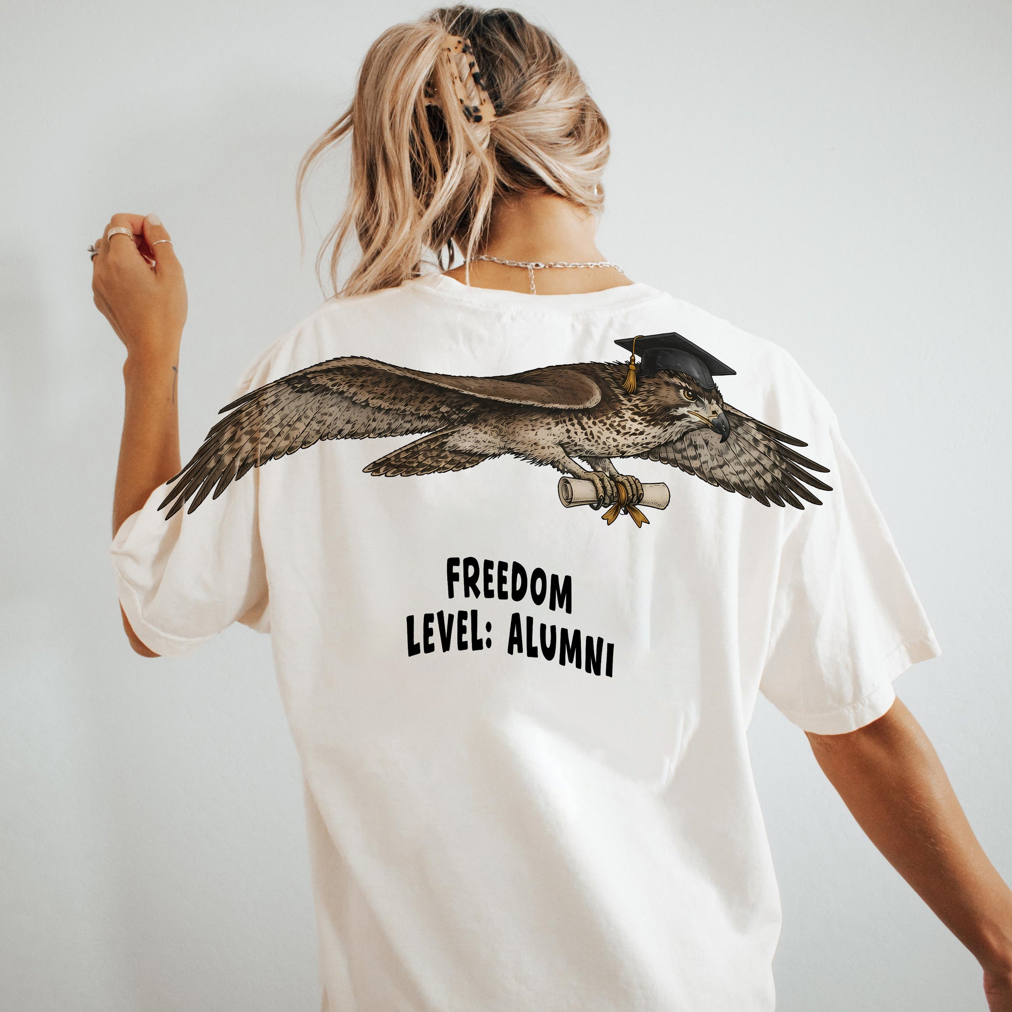Eagle Soaring Outta 26 graduation graphic tee by Dripvity, unisex oversized white t-shirt with flying bald eagle in graduation cap and diploma
