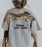 Eagle Soaring Outta 26 graduation graphic tee by Dripvity, unisex oversized white t-shirt with flying bald eagle in graduation cap and diploma