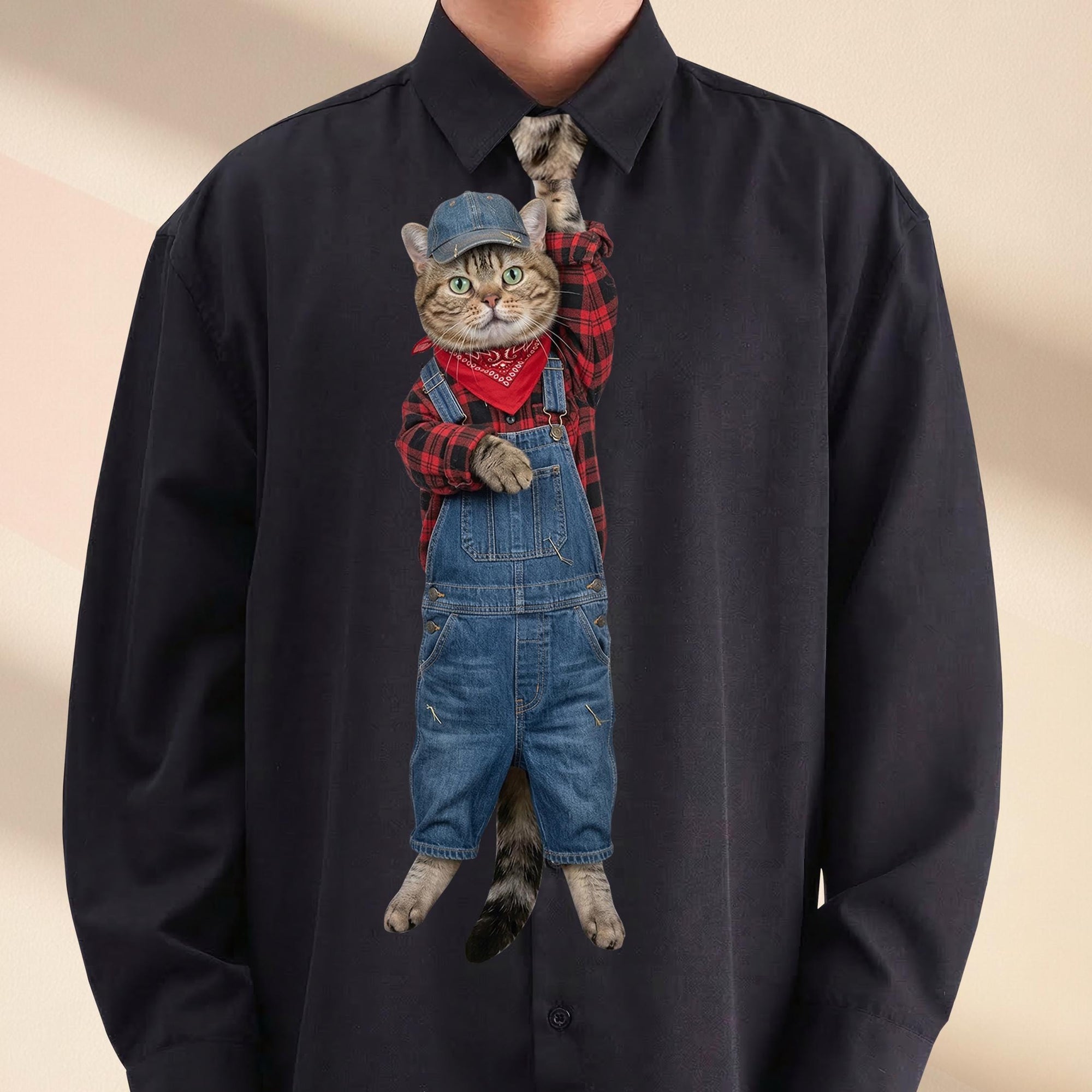 Novelty necktie featuring a tabby cat dressed as a farmer in denim overalls, a red and black plaid shirt, a red bandana, and a denim cap