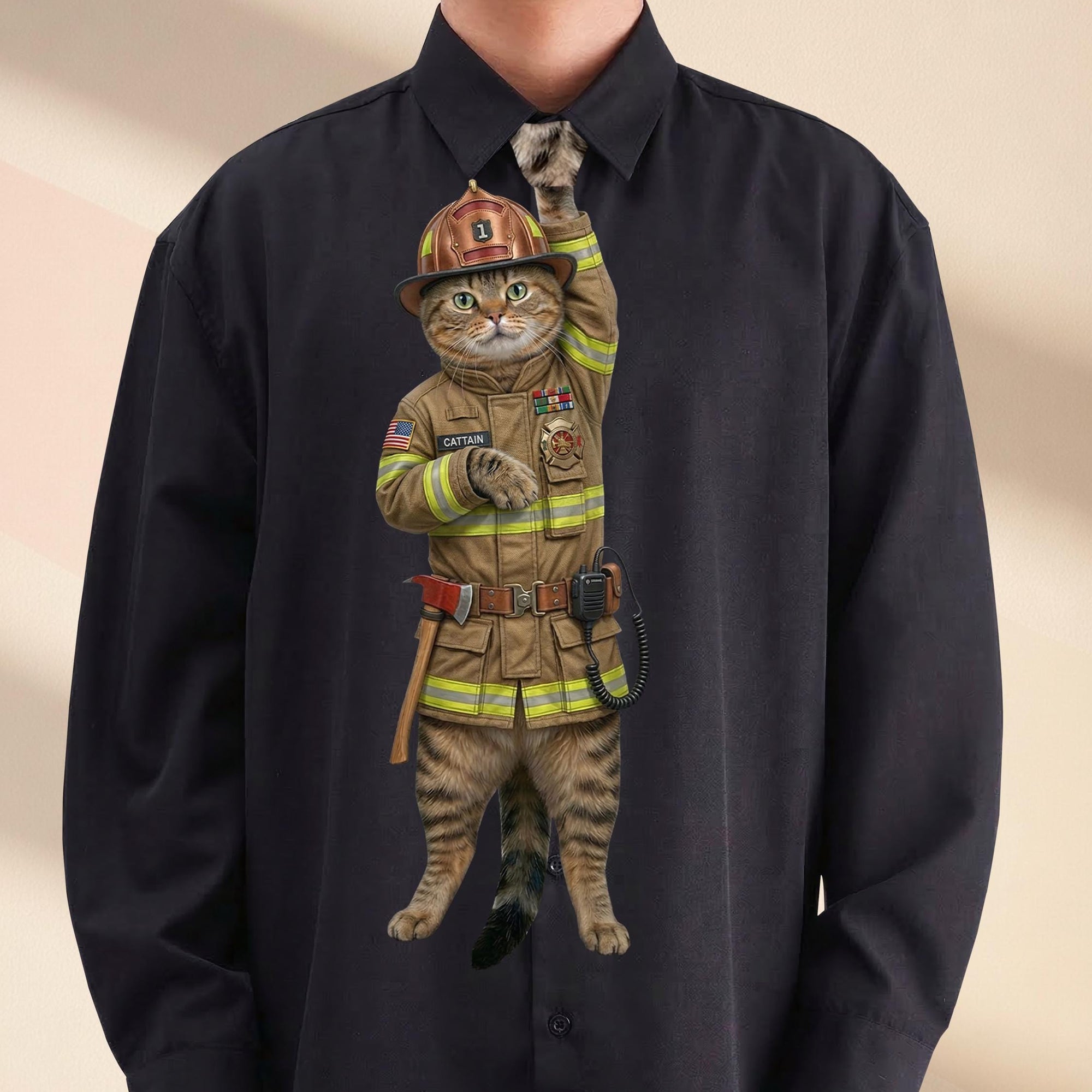 Novelty necktie featuring a tabby cat dressed as a firefighter in tan turnout gear, including a matching helmet, equipment belt, and a badge with the name 'CATTAIN'