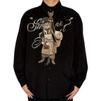 Novelty necktie featuring a tabby cat dressed as a first-time father, wearing an apron with a baby bottle and carrying a rolled blanket