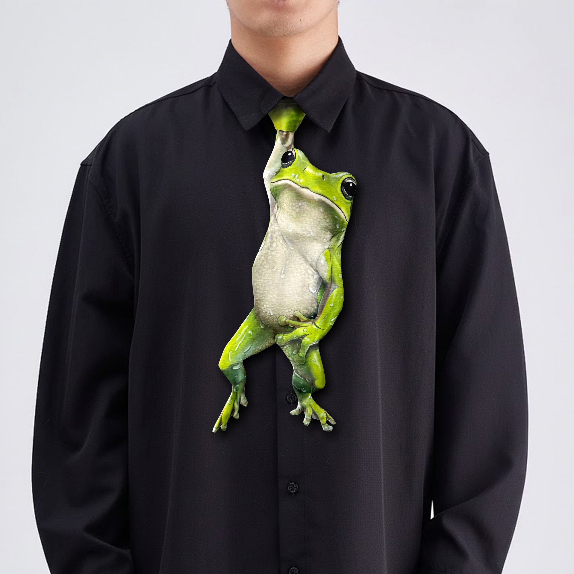Novelty necktie featuring a realistic green frog design hanging down, a fun and unique fashion accessory.