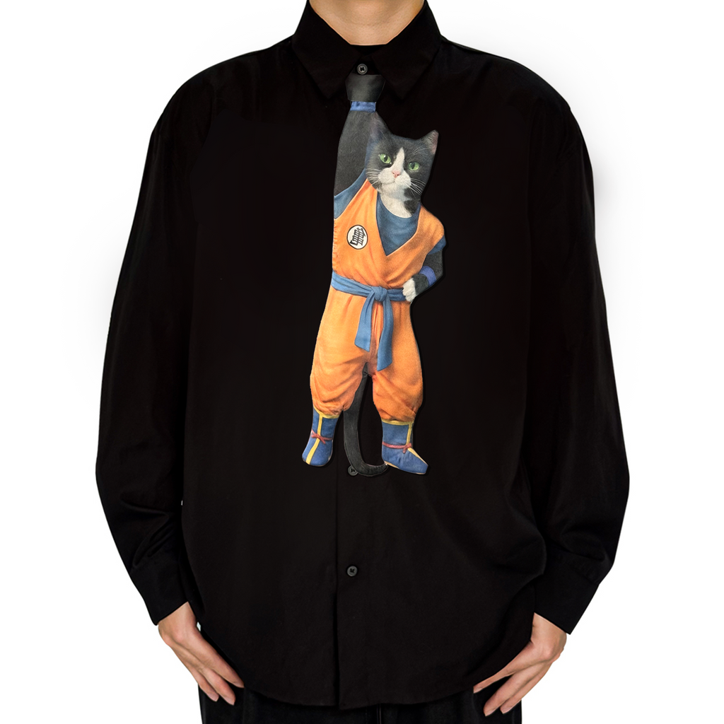 Novelty necktie featuring a creative illustration of a black and white tuxedo cat cosplaying as Goku from Dragon Ball, wearing the iconic orange gi with blue sash and boots. A unique and fun fashion accessory for anime fans.