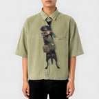 Novelty necktie featuring a black Labrador retriever dressed in a hunting vest, carrying a mallard duck in its mouth, appearing to hang from the wearer's collar