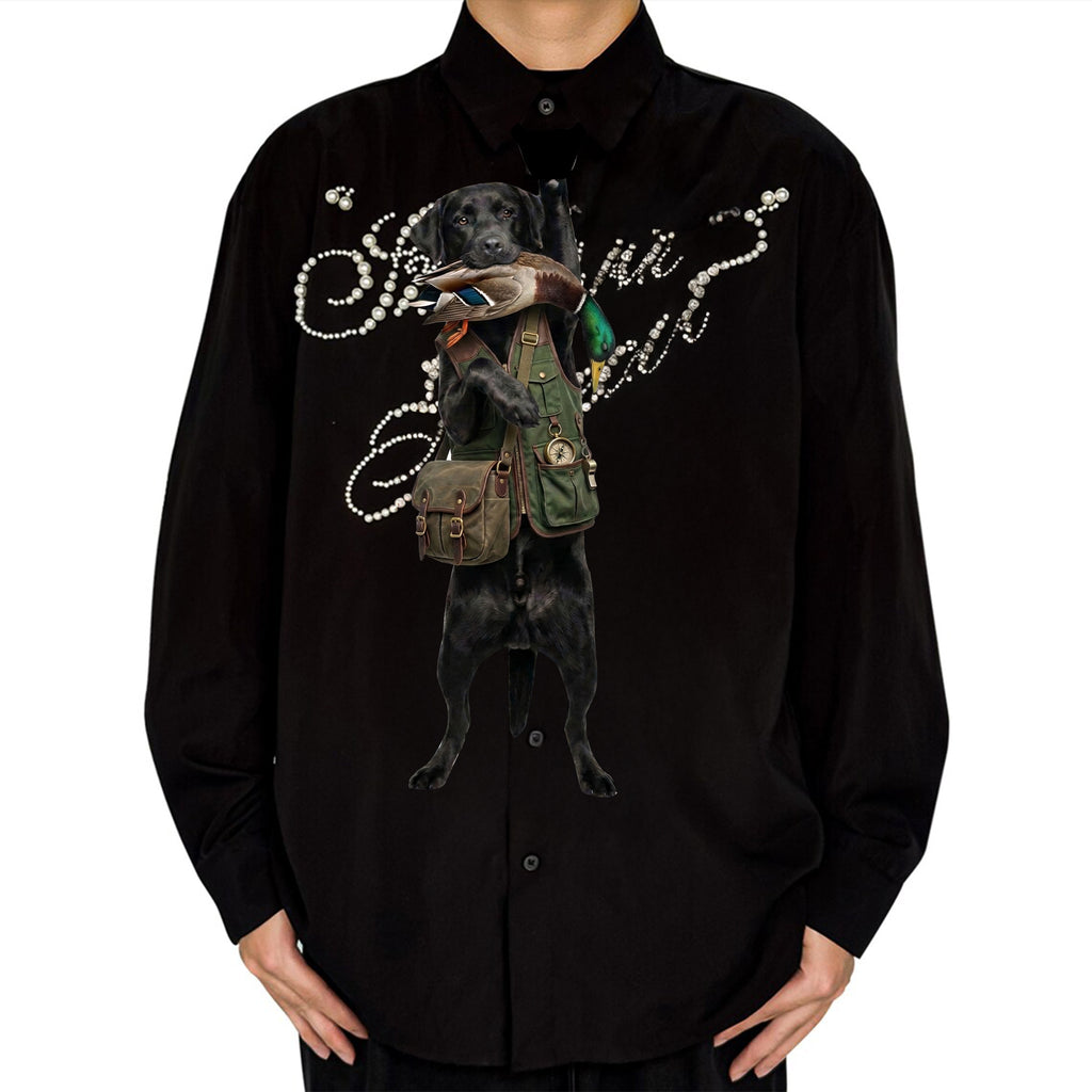 Novelty necktie featuring a black Labrador retriever dressed in a hunting vest, carrying a mallard duck in its mouth, appearing to hang from the wearer's collar
