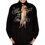 Novelty necktie featuring a realistic hanging yellow Labrador retriever design, a fun and unique fashion accessory for dog lovers.