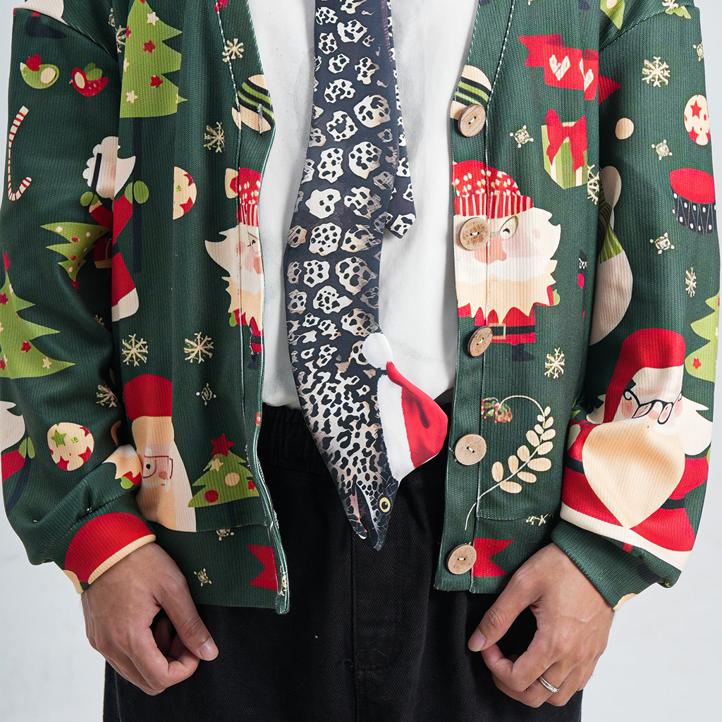 Eel-shaped novelty tie with a unique leopard print pattern and Santa hat, fun animal-themed festive accessory.