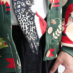 Eel-shaped novelty tie with a unique leopard print pattern and Santa hat, fun animal-themed festive accessory.