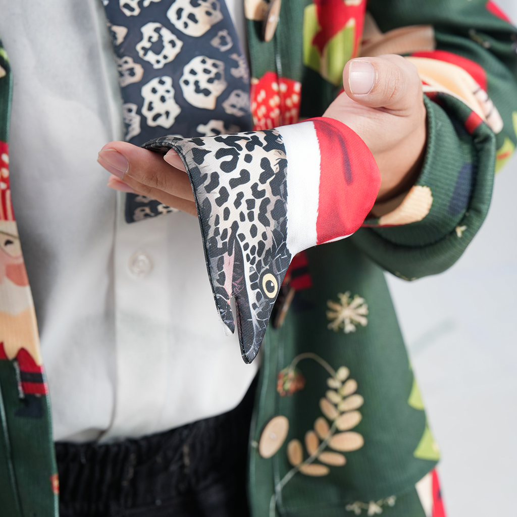 Eel-shaped novelty tie with a unique leopard print pattern and Santa hat, fun animal-themed festive accessory.