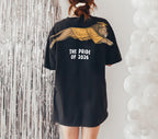 Lion The Pride of 2026 graduation graphic tee by Dripvity, unisex oversized white t-shirt with leaping lion in graduation cap and gown