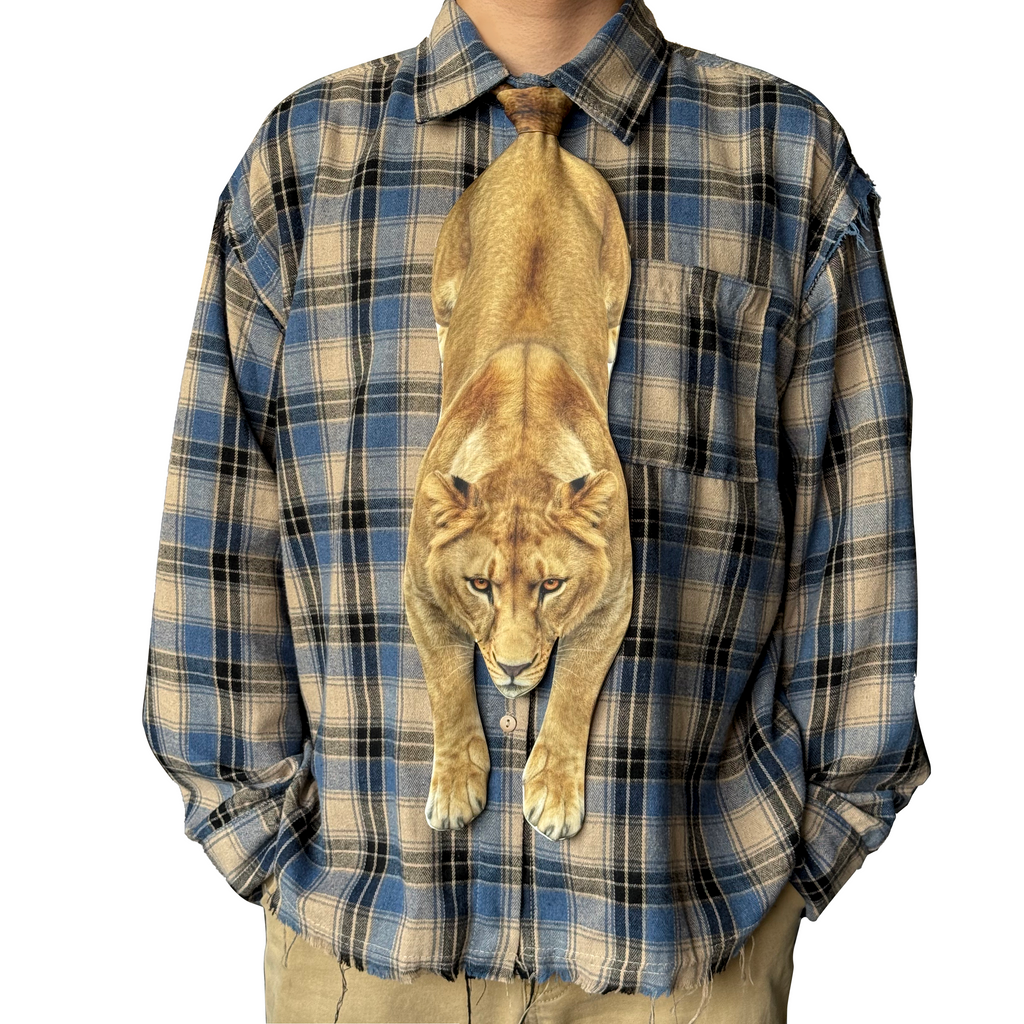 Novelty necktie featuring a realistic hanging lioness design, a bold and unique fashion accessory.