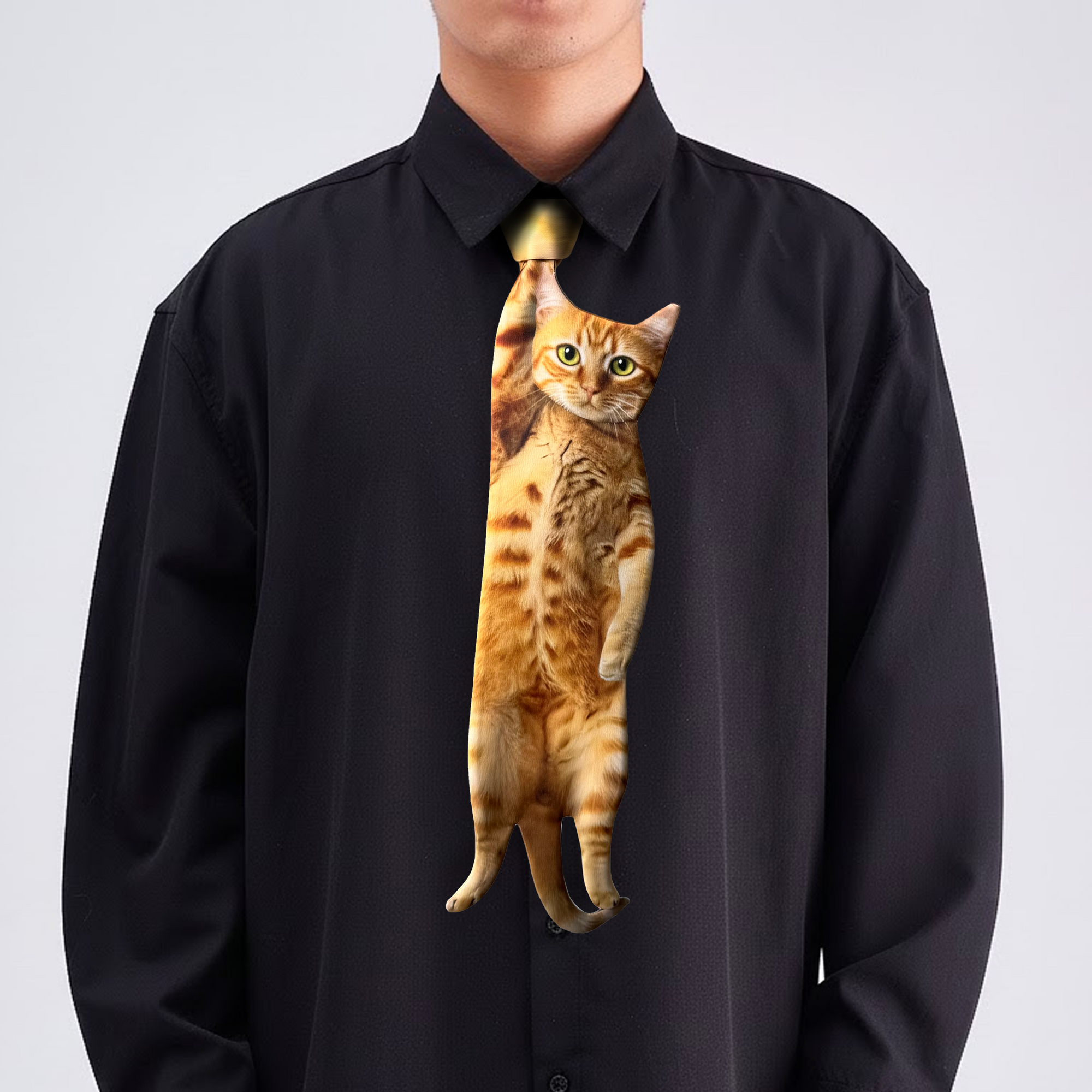 Novelty necktie featuring a realistic hanging orange tabby cat design, a fun and unique fashion accessory.