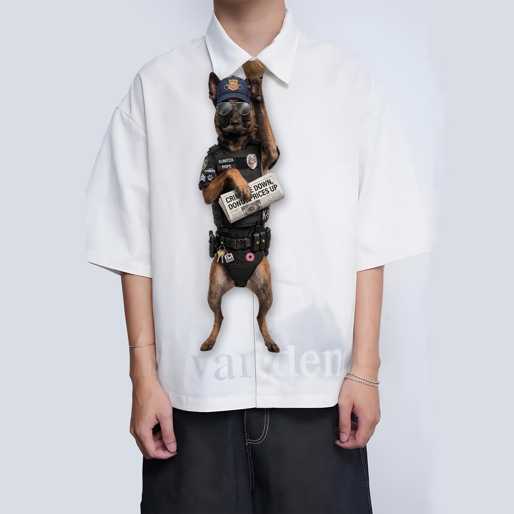 Novelty necktie featuring a Belgian Malinois dog dressed as a police officer, wearing tactical gear, sunglasses, a cap, and holding a newspaper with the headline 'CRIME DOWN, DONUT PRICES UP