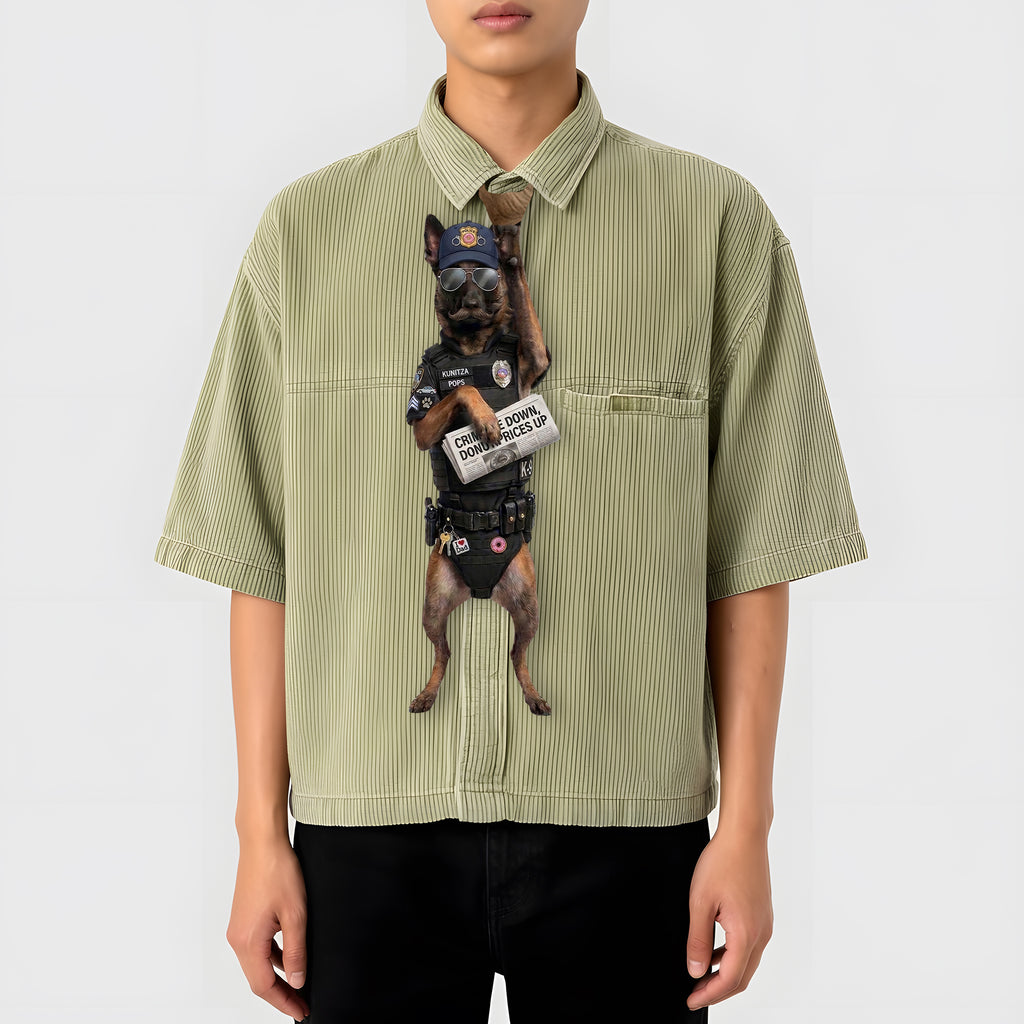Novelty necktie featuring a Belgian Malinois dog dressed as a police officer, wearing tactical gear, sunglasses, a cap, and holding a newspaper with the headline 'CRIME DOWN, DONUT PRICES UP