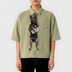 Novelty necktie featuring a Belgian Malinois dog dressed as a police officer, wearing tactical gear, sunglasses, a cap, and holding a newspaper with the headline 'CRIME DOWN, DONUT PRICES UP