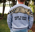 Raccoon ready to blast off 250 years graphic tee by Dripvity, unisex oversized black t-shirt with patriotic raccoon and fireworks design