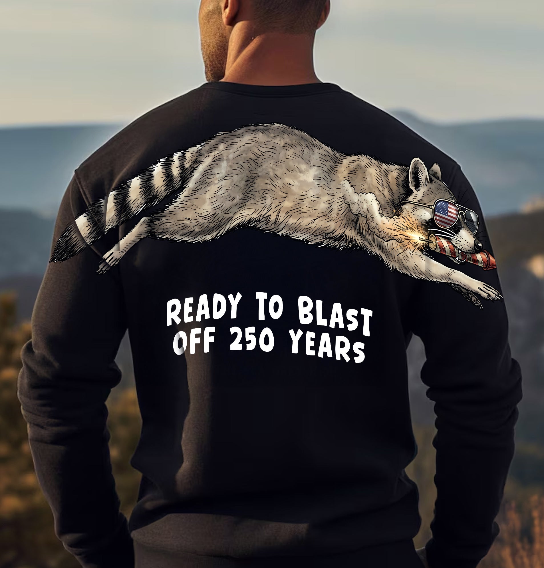 Raccoon ready to blast off 250 years graphic tee by Dripvity, unisex oversized black t-shirt with patriotic raccoon and fireworks design