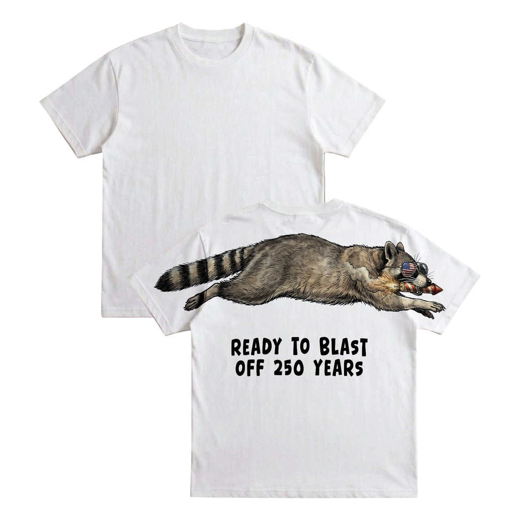 Raccoon ready to blast off 250 years graphic tee by Dripvity, unisex oversized black t-shirt with patriotic raccoon and fireworks design