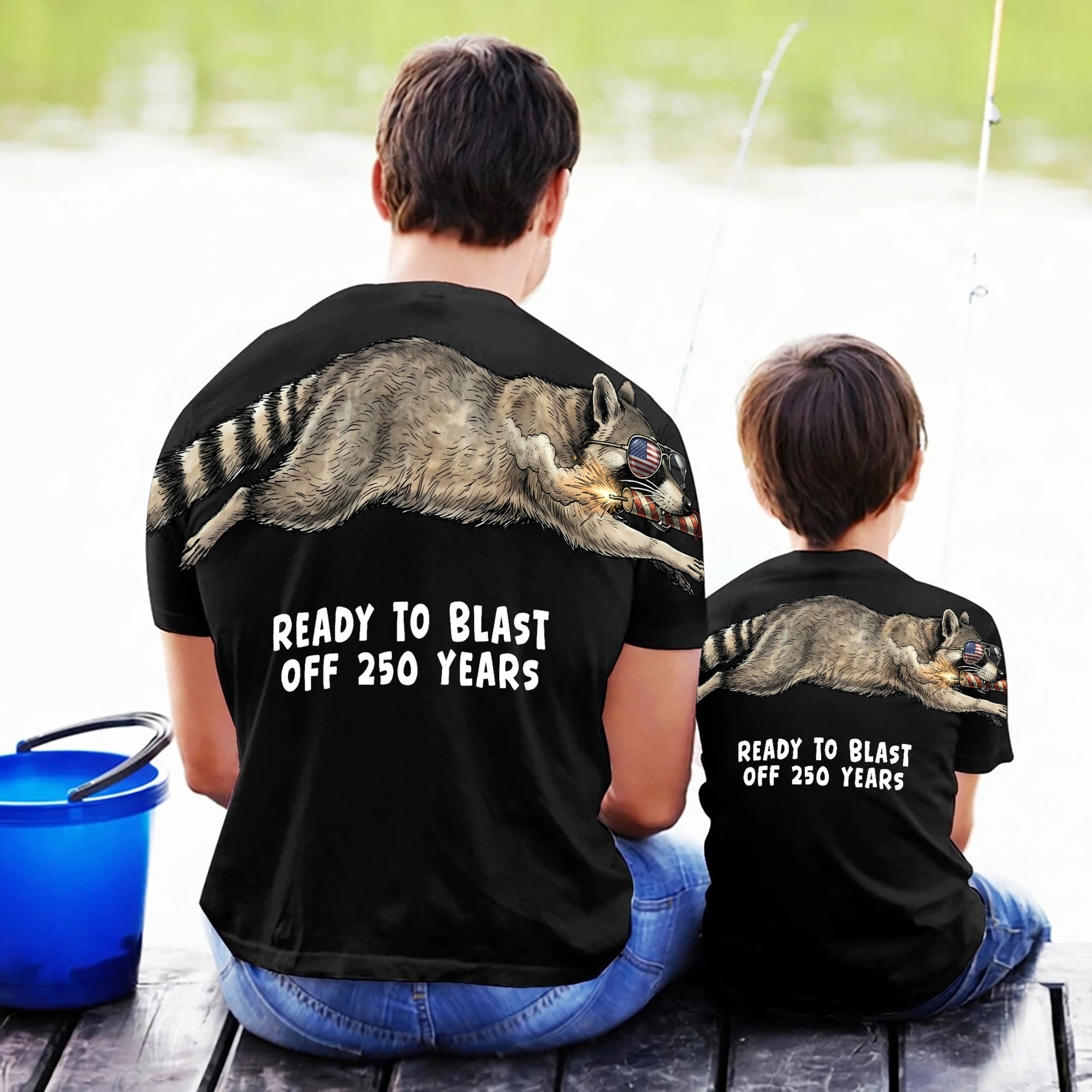 Raccoon ready to blast off 250 years graphic tee by Dripvity, unisex oversized black t-shirt with patriotic raccoon and fireworks design