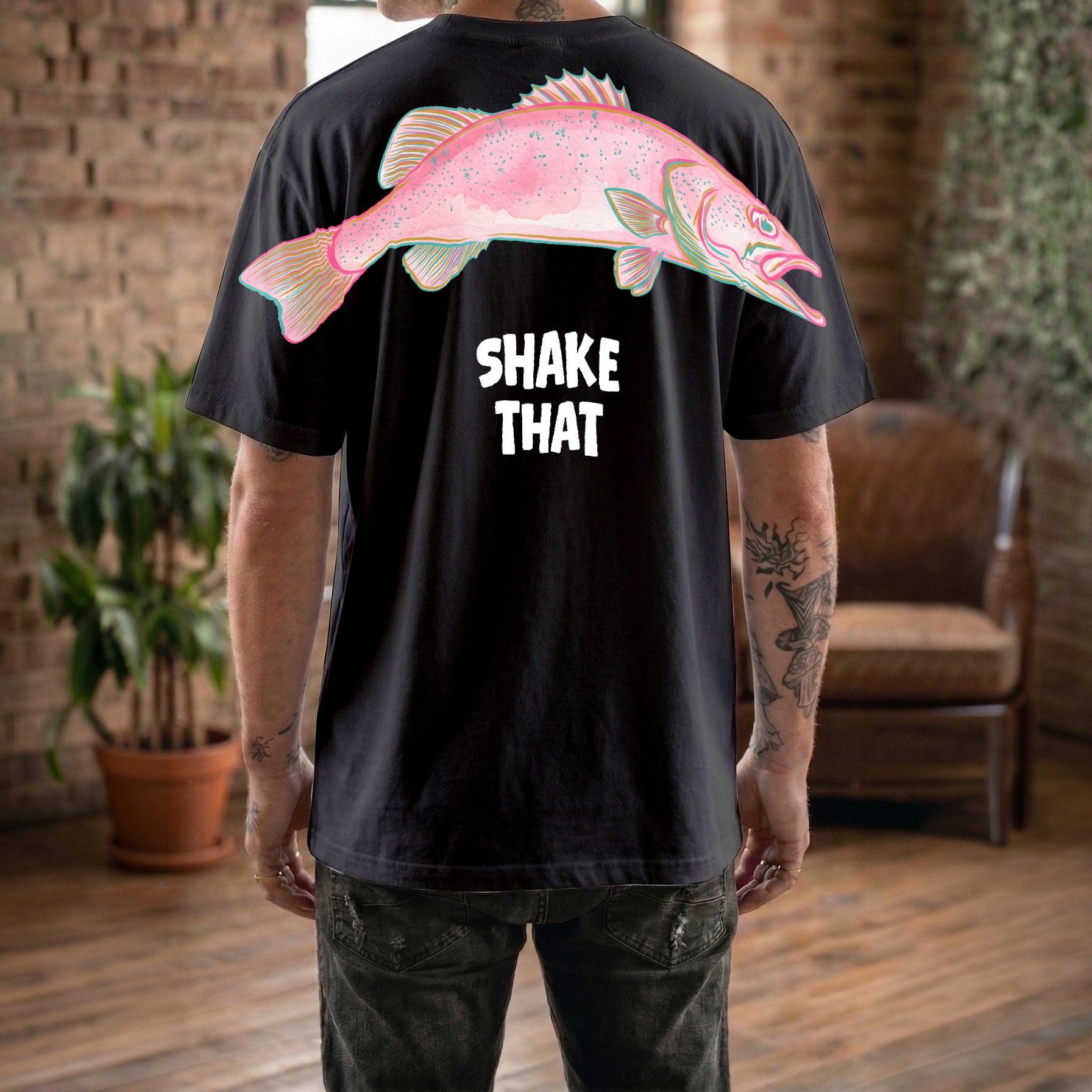 Shake That fish graphic tee funny streetwear by Dripvity, unisex oversized white t-shirt with colorful pink fish and bold text design