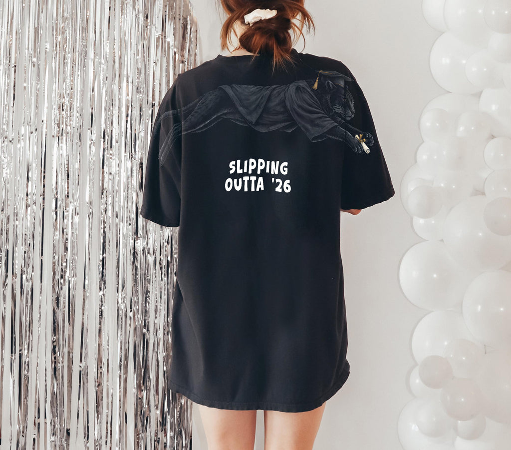 Slipping Outta 26 Panther Graduation Graphic Tee By Dripvity. Edgy unisex oversized black washed t-shirt with leaping panther in graduation cap. Perfect 2026 senior graduation streetwear gift. Shop now!