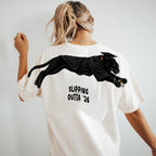 Slipping Outta 26 Panther Graduation Graphic Tee By Dripvity. Edgy unisex oversized black washed t-shirt with leaping panther in graduation cap. Perfect 2026 senior graduation streetwear gift. Shop now!