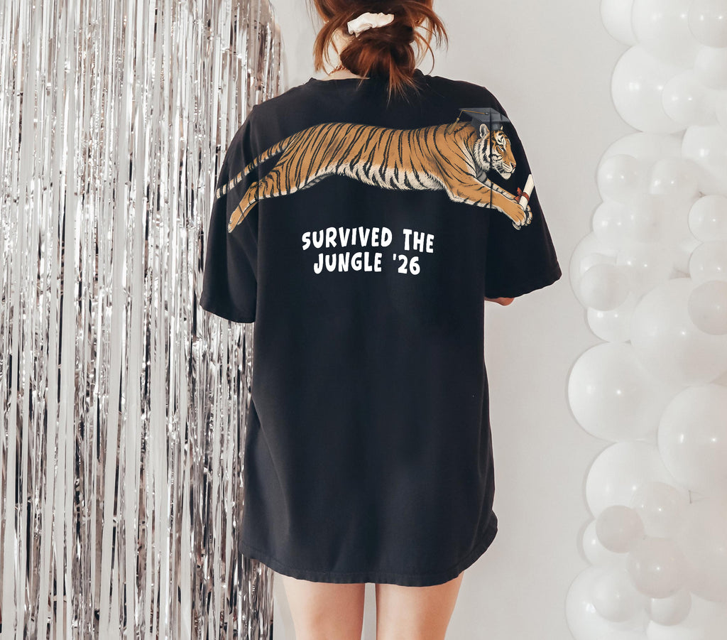 Tiger Survived The Jungle 26 graduation graphic tee by Dripvity, unisex oversized white t-shirt with leaping tiger in graduation cap and diploma