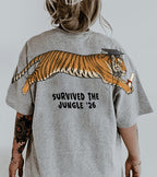 Tiger Survived The Jungle 26 graduation graphic tee by Dripvity, unisex oversized white t-shirt with leaping tiger in graduation cap and diploma