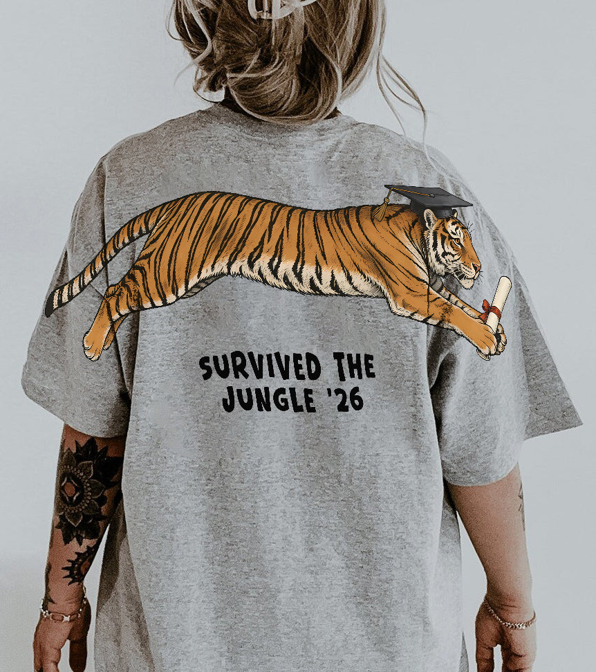 Tiger Survived The Jungle 26 graduation graphic tee by Dripvity, unisex oversized white t-shirt with leaping tiger in graduation cap and diploma