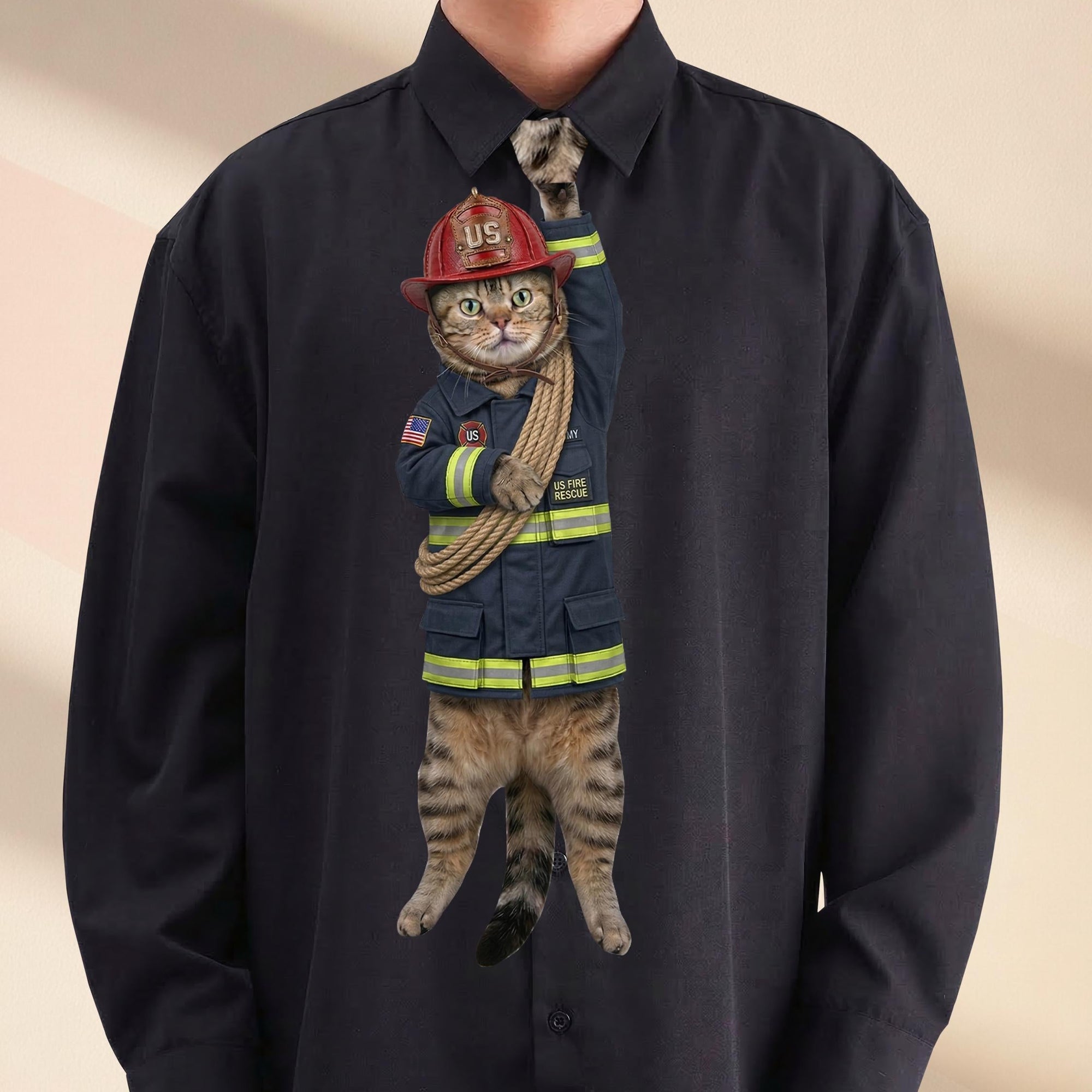 Novelty necktie featuring a tabby cat dressed as a U.S. fire rescue worker in a dark blue uniform with yellow reflective stripes, wearing a red helmet and carrying a coiled rescue rope