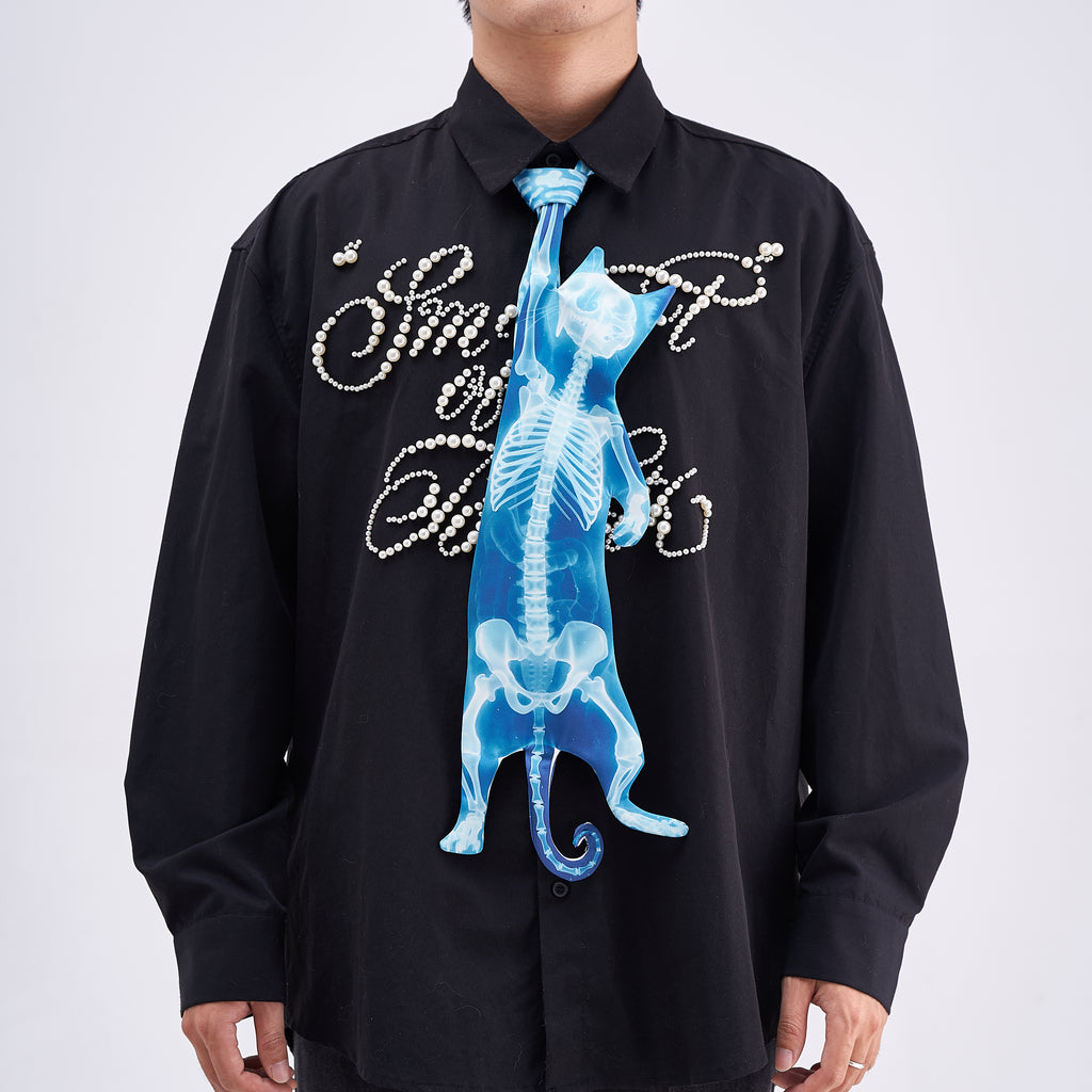 Unique novelty necktie featuring a blue X-ray skeleton design of a cat, an edgy and artistic fashion accessory.