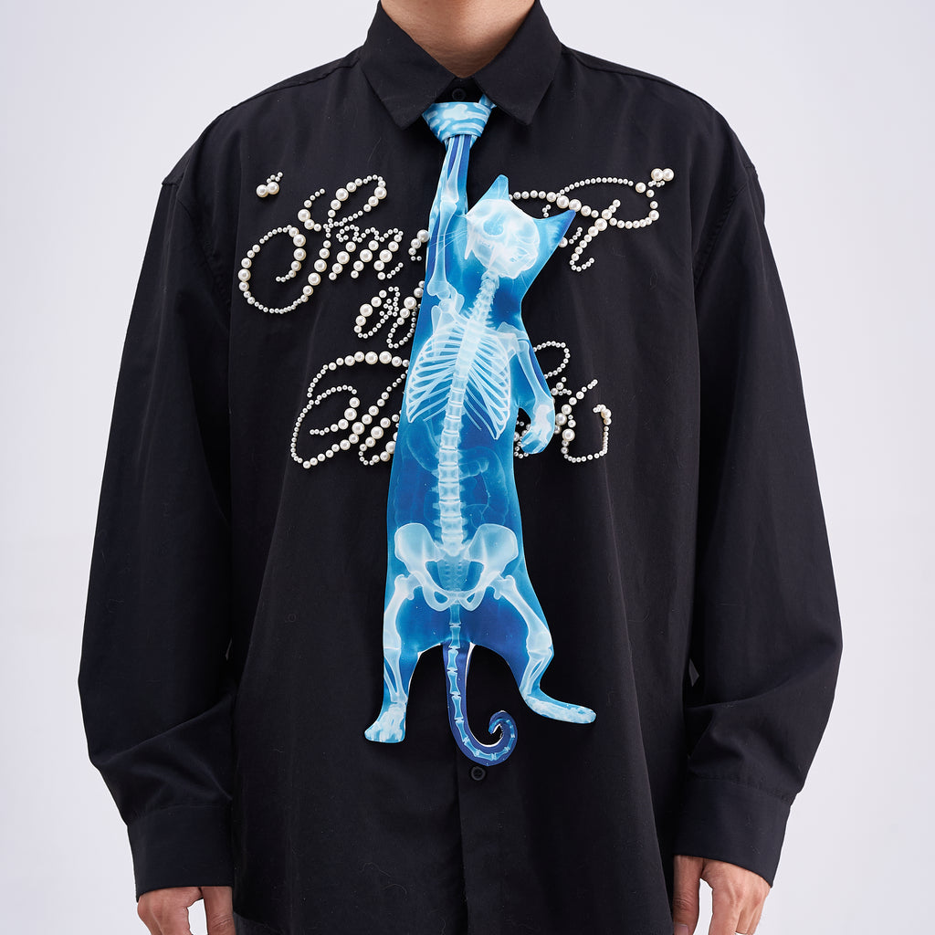 Unique novelty necktie featuring a blue X-ray skeleton design of a cat, an edgy and artistic fashion accessory.
