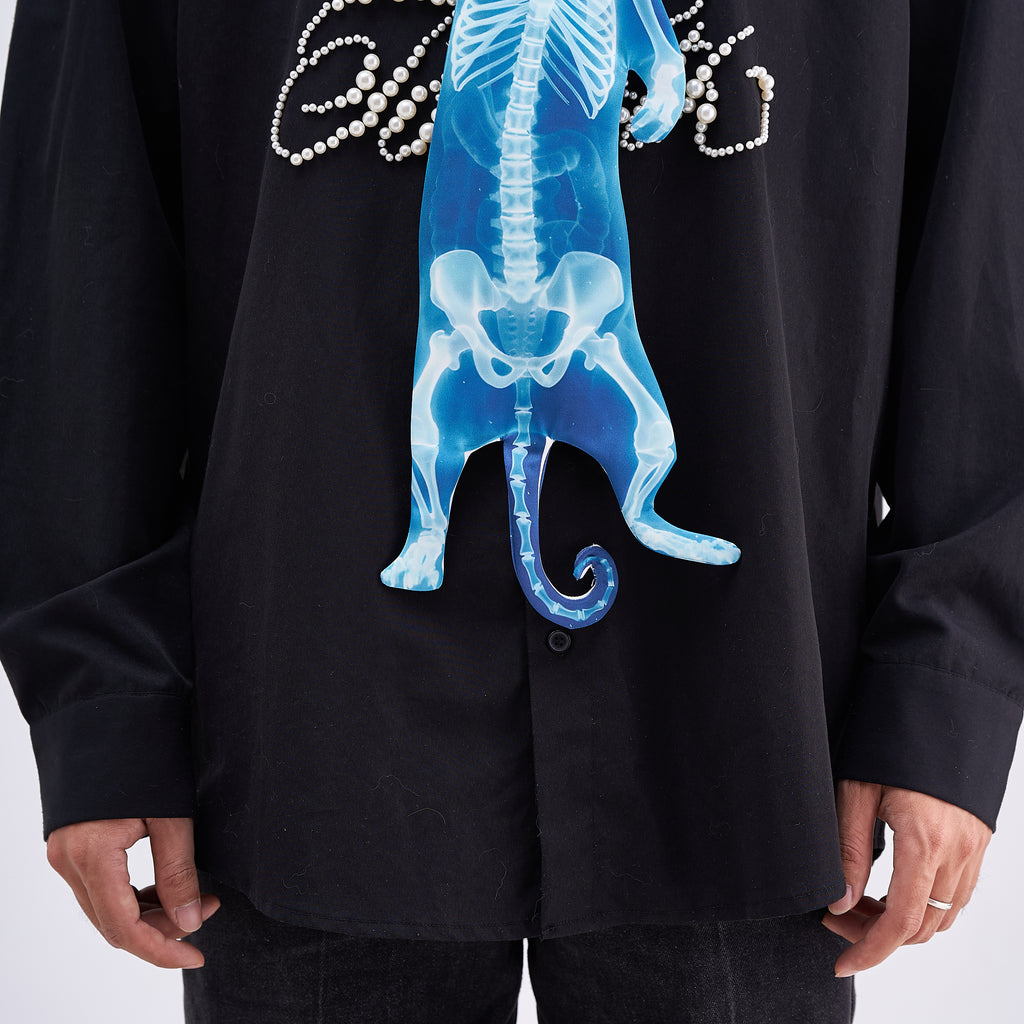Unique novelty necktie featuring a blue X-ray skeleton design of a cat, an edgy and artistic fashion accessory.