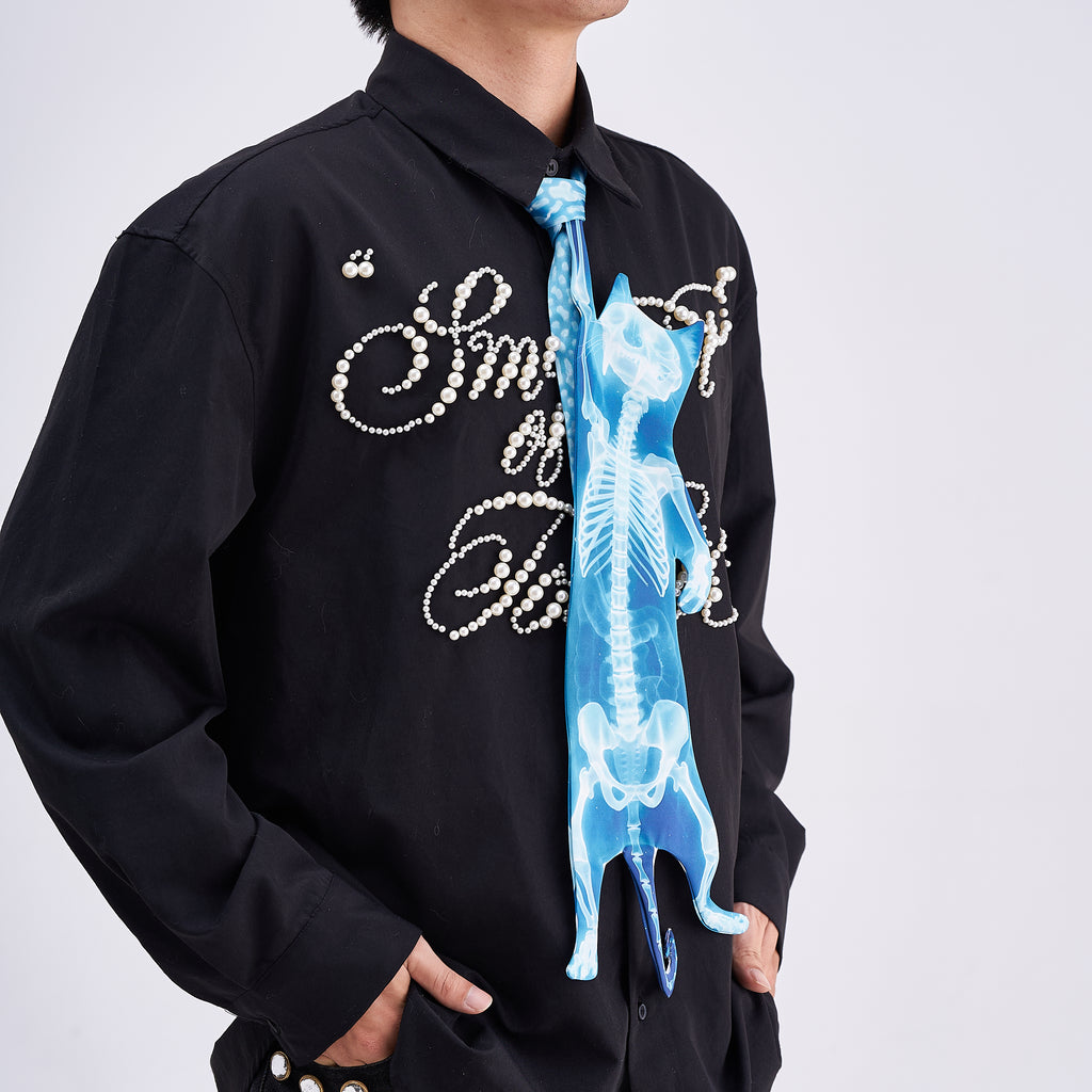 Unique novelty necktie featuring a blue X-ray skeleton design of a cat, an edgy and artistic fashion accessory.